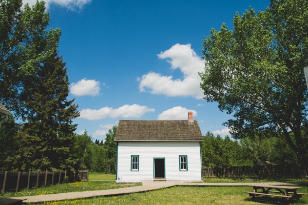 an older house that has the picture taken from the driveway